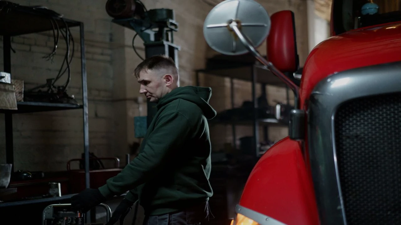 Mechanic inspecting a red truck in a garage