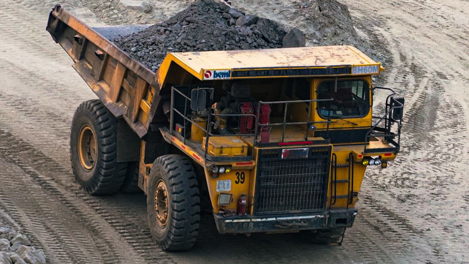 Heavy outdoor equipment working across a mining site