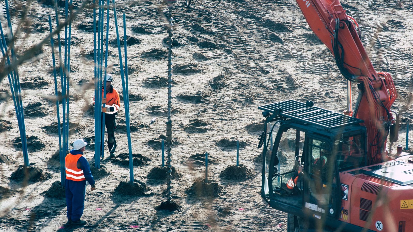 Technician servicing construction equipment at an outdoor site