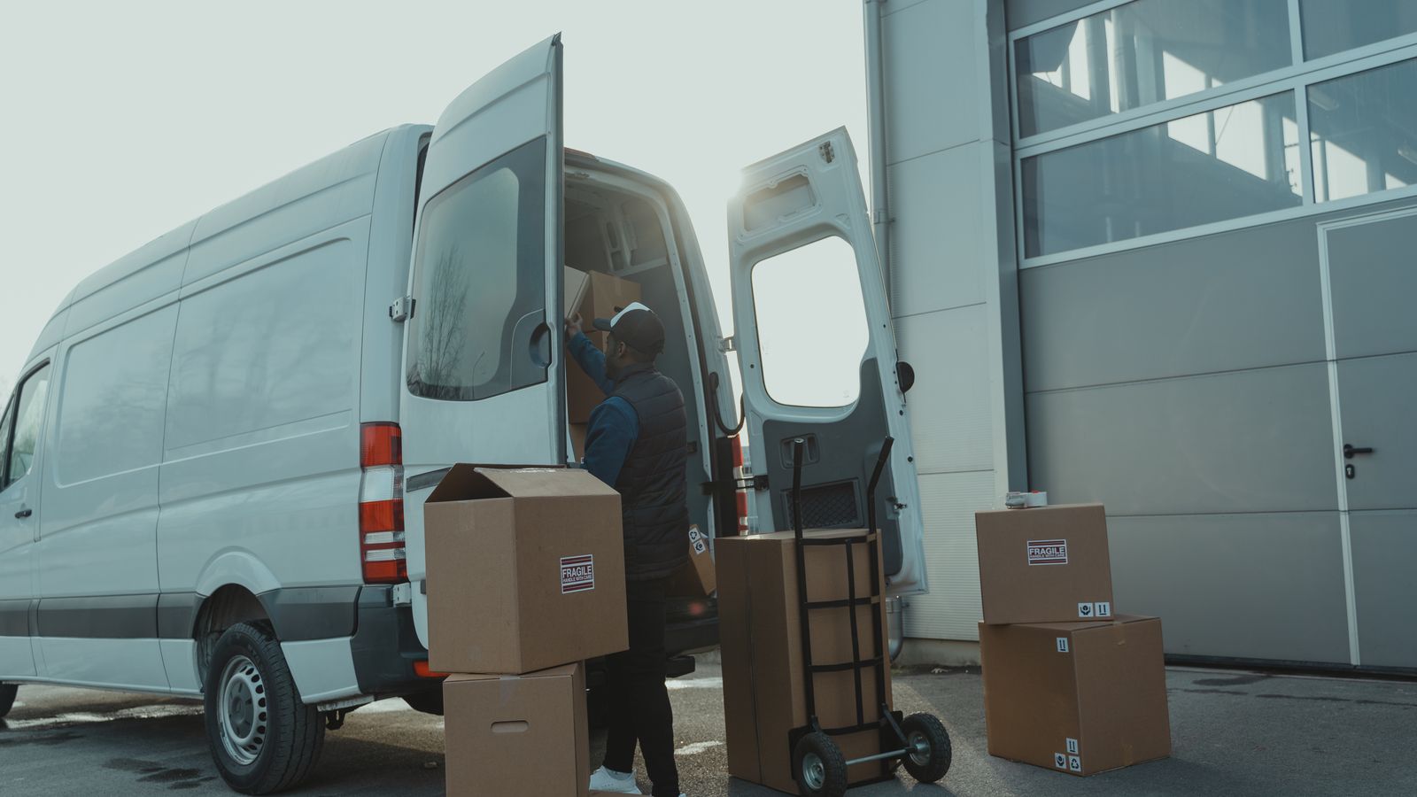 Last-mile delivery team working beside a light service vehicle