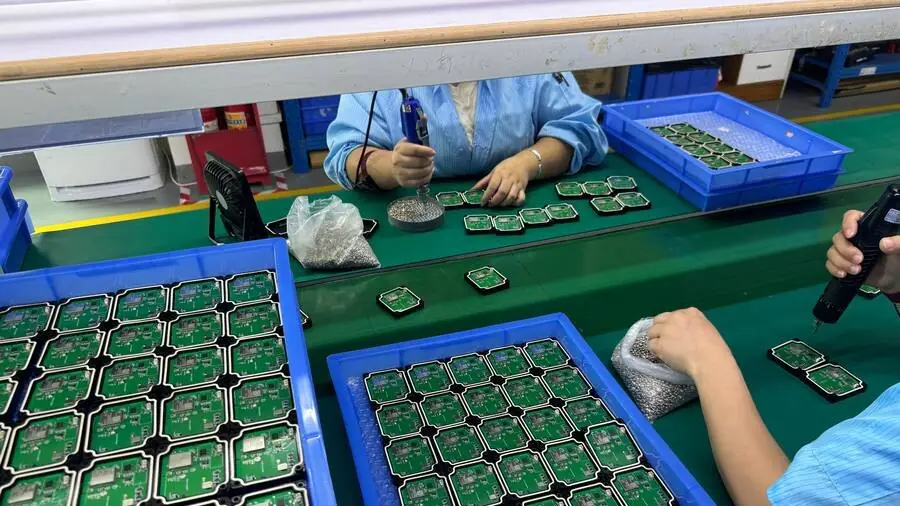 GPS tracker boards being assembled into housings at a Shenzhen partner facility